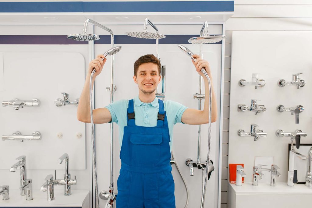 plumber holding a shower nozzles