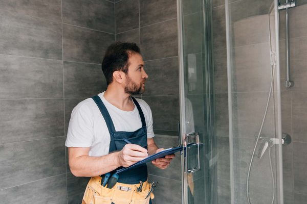 plumber checking shower equipment