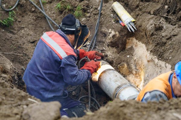 plumber fixing sewage pipes