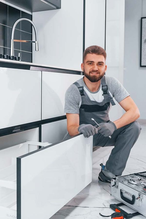 a plumber with a plumbing tool box beside