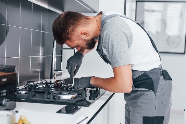 a professional plumber fixing gas stove